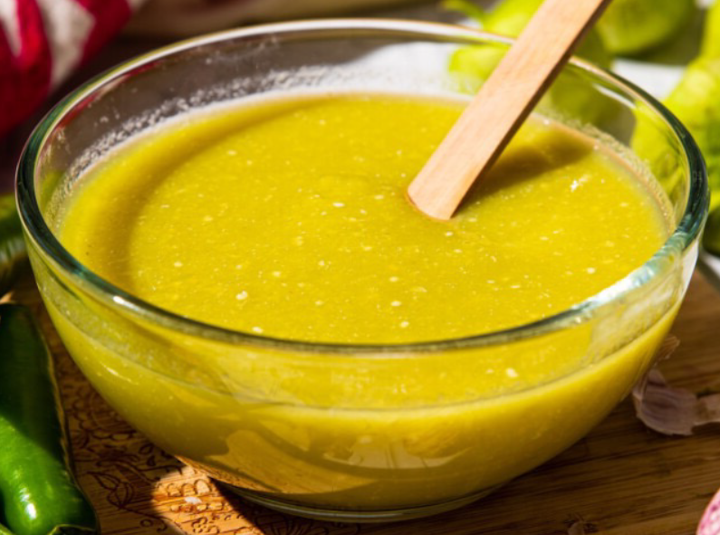 green tomatillo salsa presented in a glass bowl