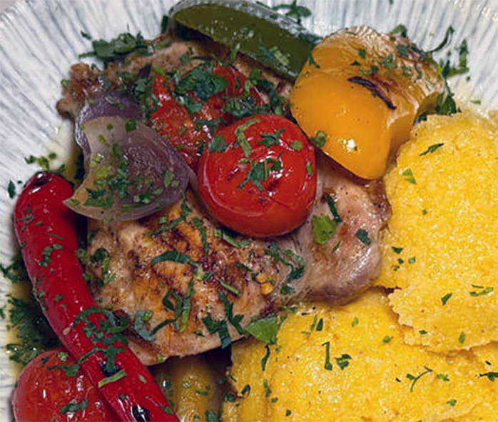 fried carp served with polenta, tomatoes and bell pepper