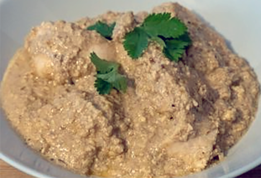 Satsabeli bazha, chicken in walnut sauce served on a plate