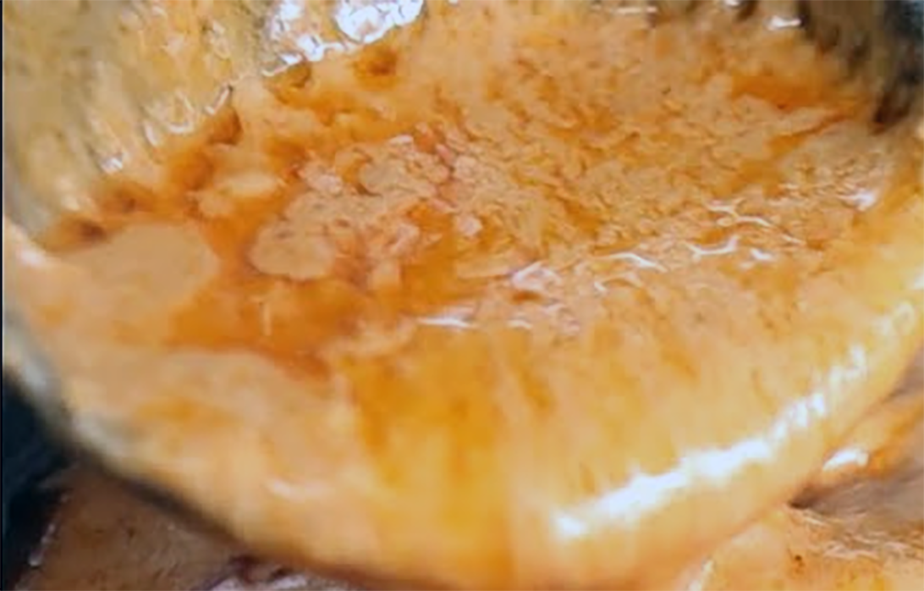 Congolese peanut sauce in a ladel