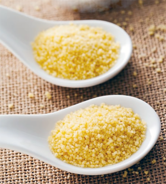 Yellow semolina presented on a white spoon