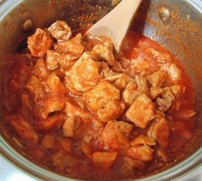 pork prokolt cooking in a deep stew pan