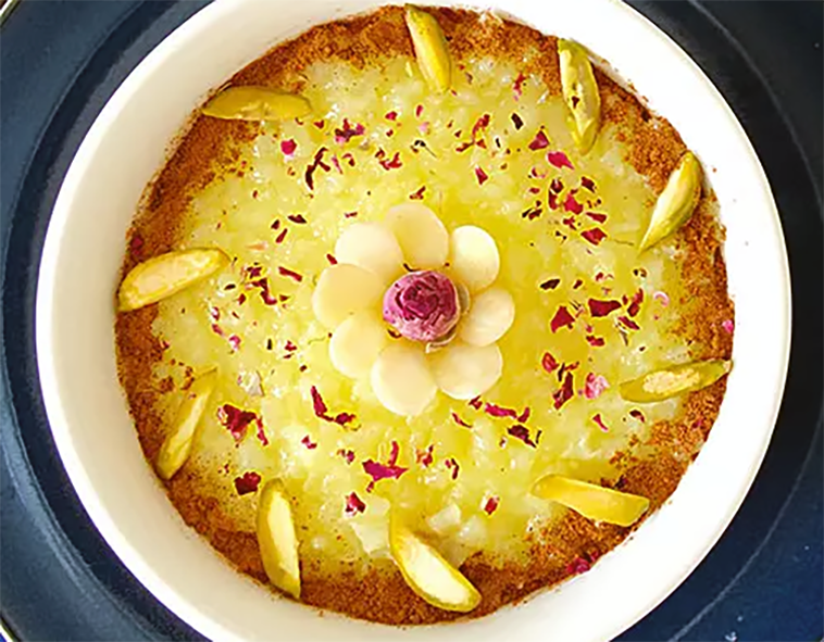 Sholeh Zard, Persian yellow rice pudding served decorated in a round pudding bowl