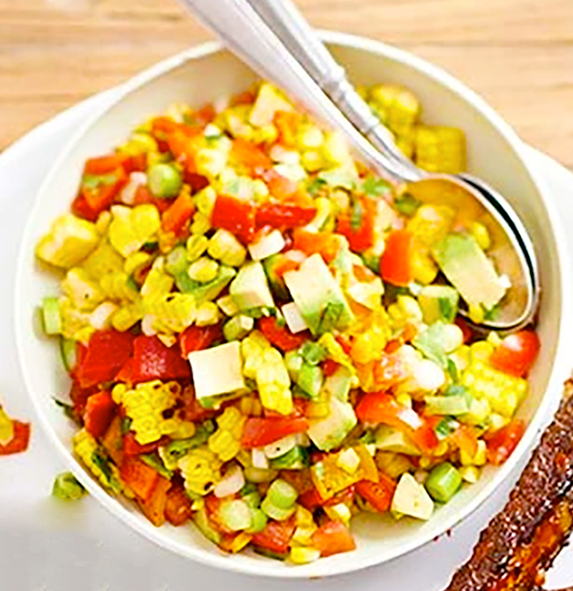 smoky sweetcorn and avocado salsa served in a white bowl with two spoons