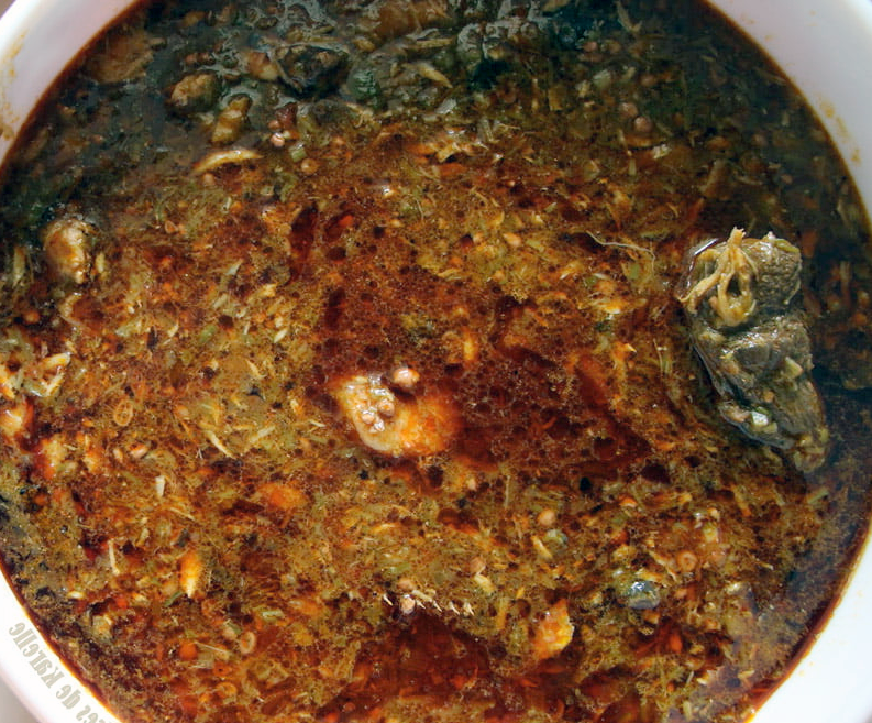 Goat meat stew with okra and fermented locust beans served in a bowl