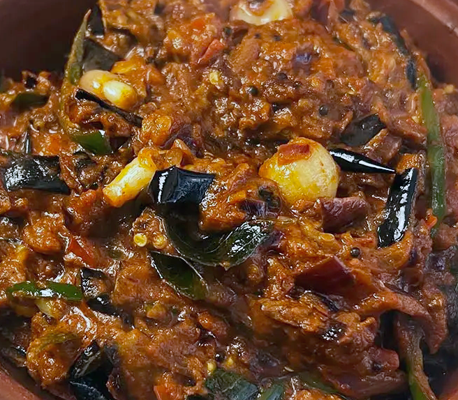 Sri Lankan aubergine curry served in an earthenware dish