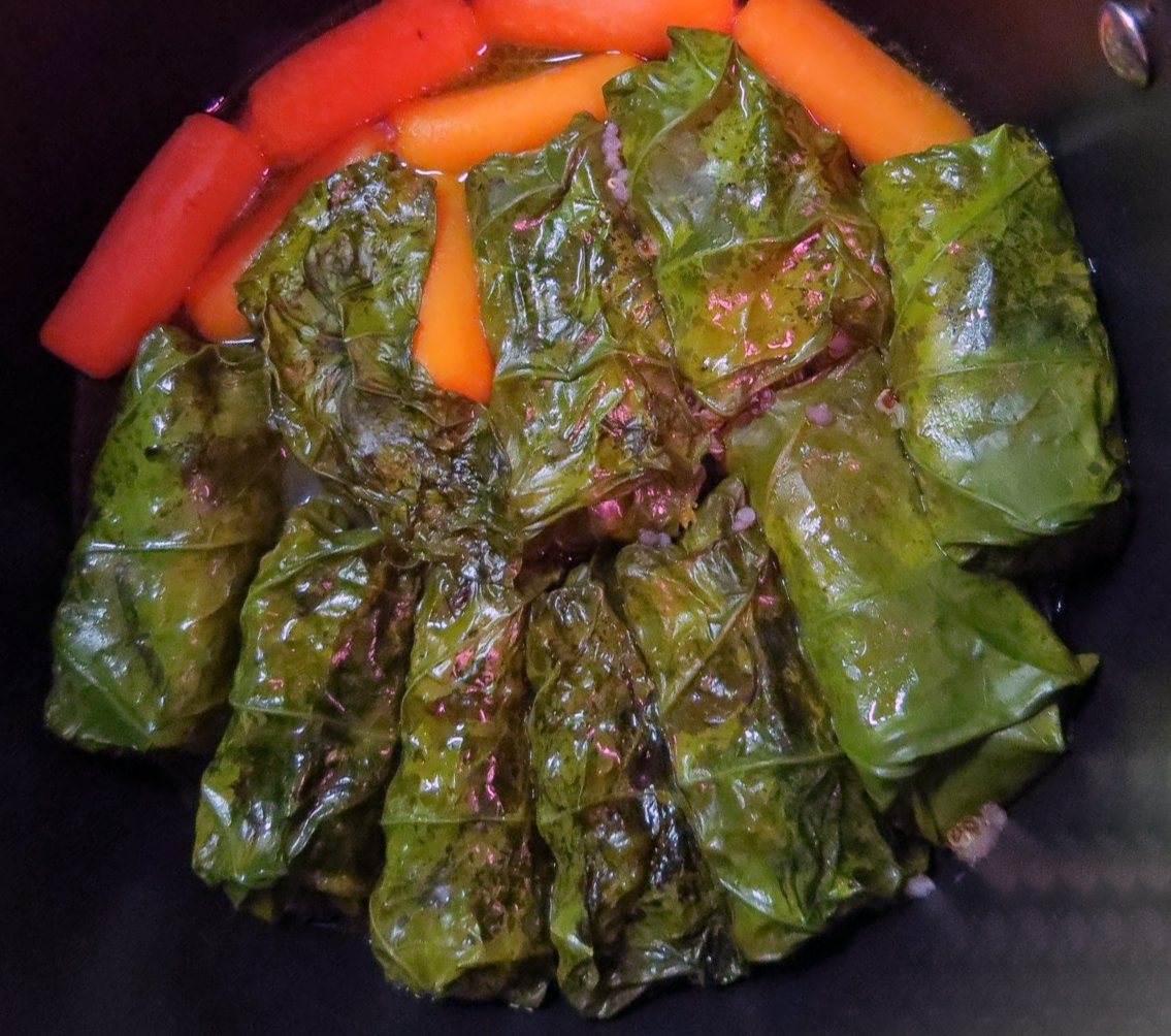 Stuffed nasturtium leaves in a steamer with carrots