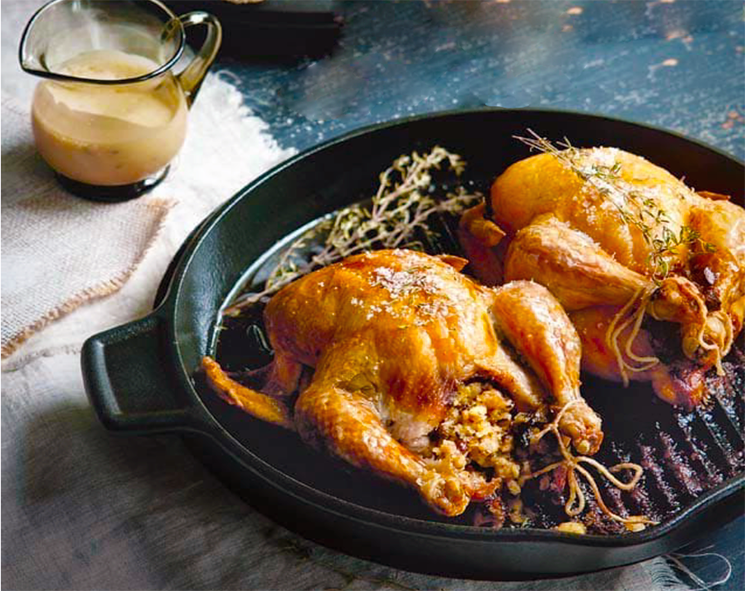 stuffed poussin on a griddle with a jug of madeira sauce