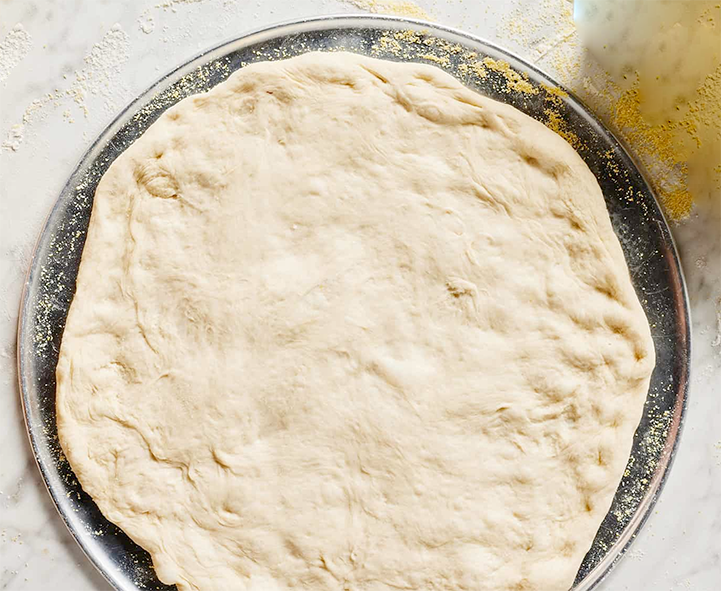 Stretched-out sweet pizza dough presented on a plate