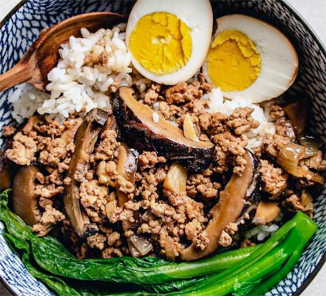 Braised minced pork served garnished with hard-boiled eggs over rice in a bowl