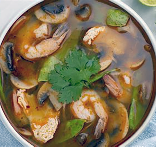 Thai shrimp soup served in a bowl garnished with coriander leaves