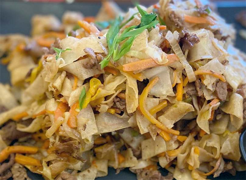 Tsuvian, noodles, vegetables and meat served on a plate