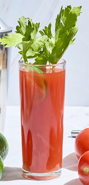 Virgin Mary cocktail in a highball glass served with a garnish of celery leaves