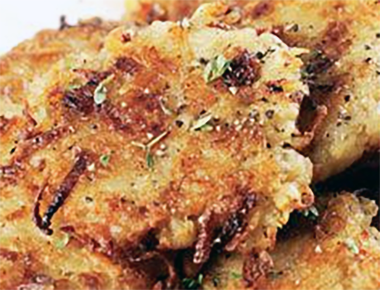 Welsh breakfast rosti or potato, cheese, leek and laverbread piled on each other on a plate