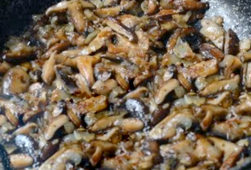 mixed wild mushroom compote in a frying pan