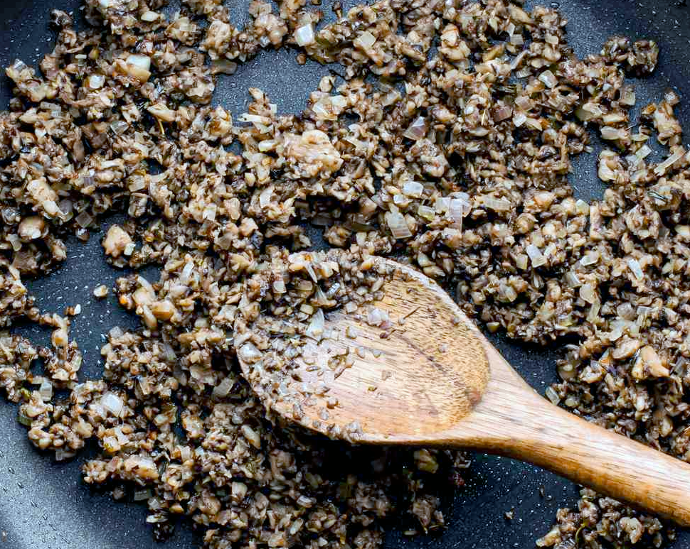 dried wild mushroom and shallot duxelles frying in a pan