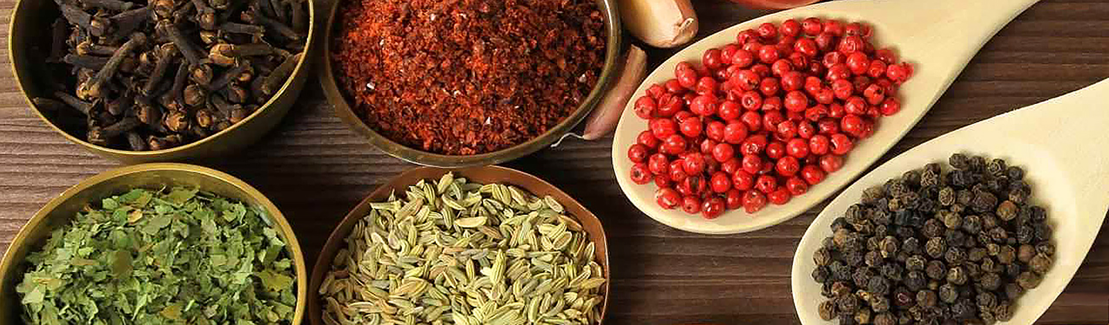 Herbs and spices on wooden spoons